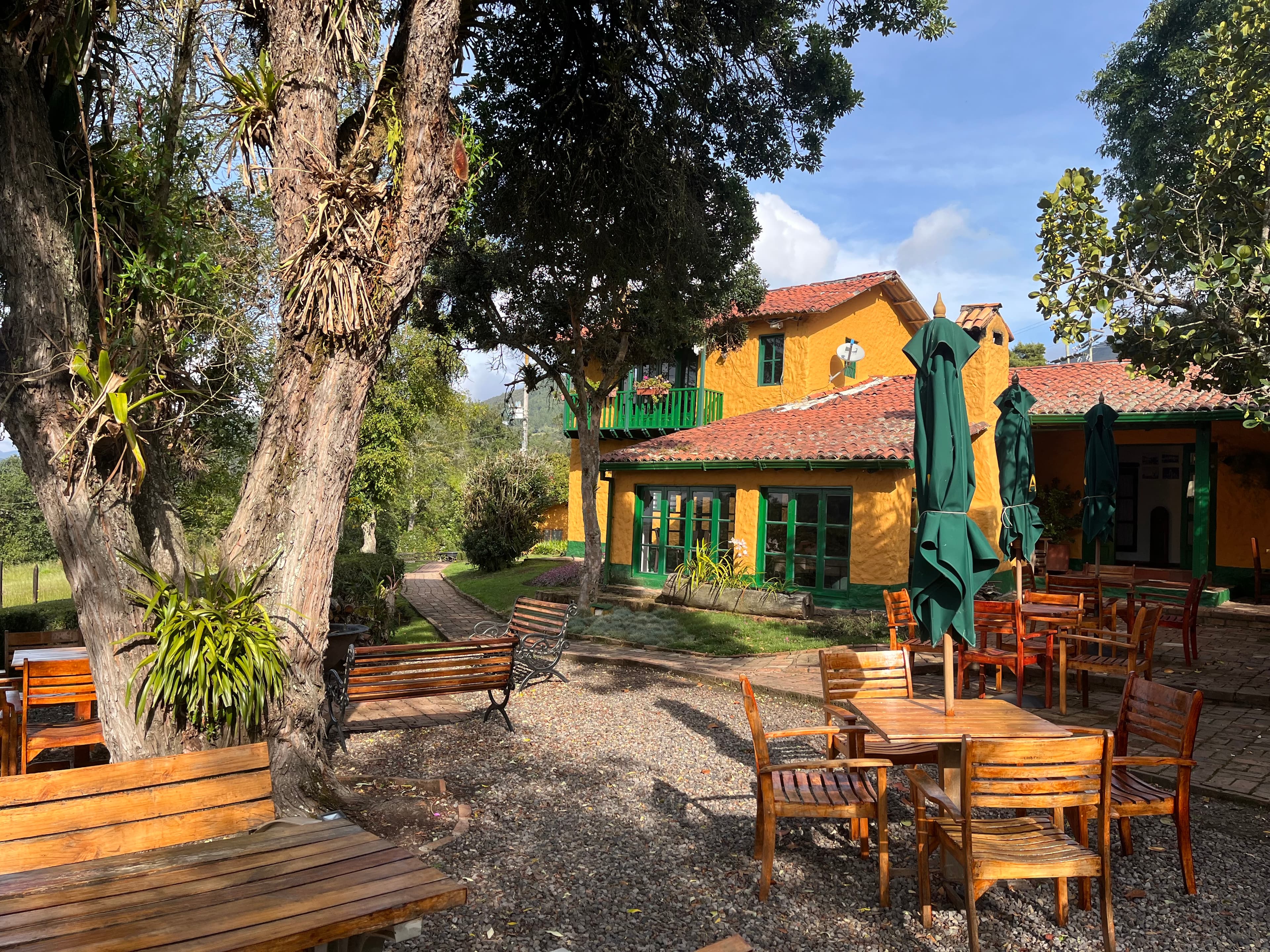 Hacienda-style venue with grand tree and outdoor dining in Guasca